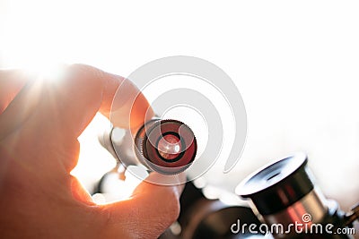 Telescope close up on a light background with sunlight, small depth of field Stock Photo