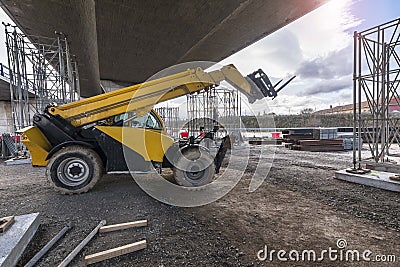 Telescopic elevator in the construction works of an overpass Editorial Stock Photo