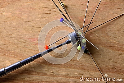 TELESCOPIC MAGNET WITH GLASS HEAD PINS STUCK TO IT Stock Photo