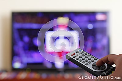 Televesion remote control in the hand, zapping Stock Photo