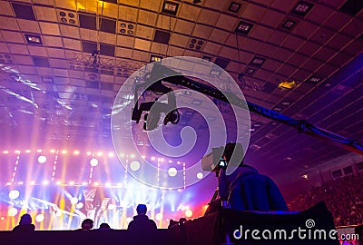 Television broadcast by a cameraman during a concert. Camera with the operator is on the high platform. Editorial Stock Photo