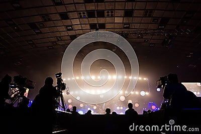 Television broadcast by a cameraman during a concert. Camera with the operator is on the high platform Stock Photo