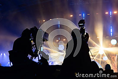 Television broadcast by a cameraman during a concert. Camera with the operator is on the high platform Stock Photo