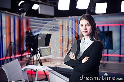 Television presenter recording in news studio.Female journalist anchor presenting business report,recording in television studio Stock Photo