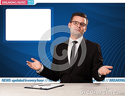 Television reporter telling breaking news at his studio desk wit Stock Photo