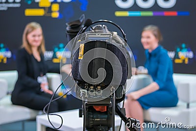 Television video camera recording interview in broadcast news studio Editorial Stock Photo