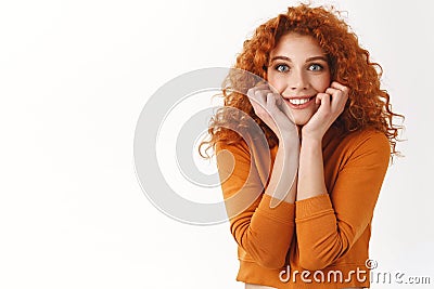 Tell me everything. Cheerful excited redhead female friend wanna know details gossiping, smiling thrilled, touch face Stock Photo