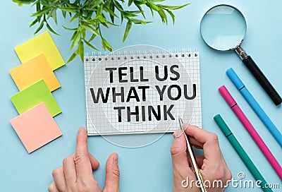 Tell us what you think text written on black notebook with magnifying glass and a pen. Business and achievement concept Stock Photo