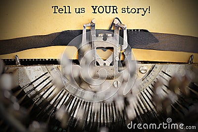 Tell us your story text typed on vintage paper by retro typewriter Stock Photo