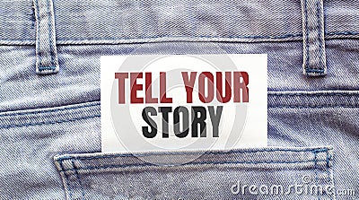 TELL YOUR STORY words on a white paper stuck out from jeans pocket. Business concept Stock Photo