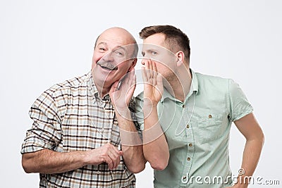 Mature father ans son having some secrets. Stock Photo