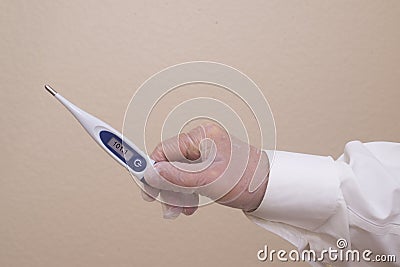 Physcian or nurse holding a thermometer with a high temprature reading . Stock Photo