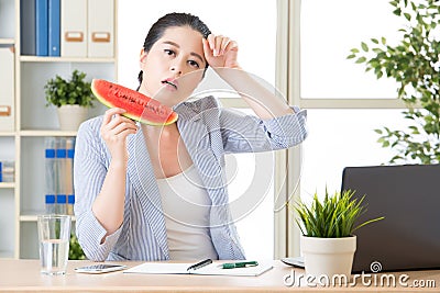 The temperature is too high in office, woman is sweating Stock Photo