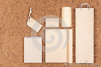 Template of blank kraft recycled paper packaging and stationery on brown coconut fiber background. Stock Photo
