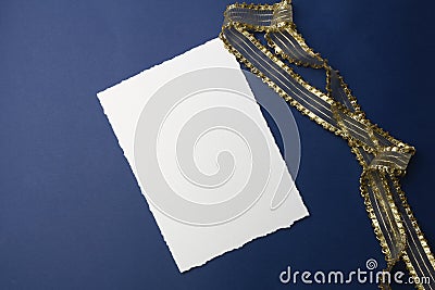 Mock-up for invitations, greetings. On a blue background, a white sheet of paper, an envelope, a notebook, a ring with stones, an Stock Photo