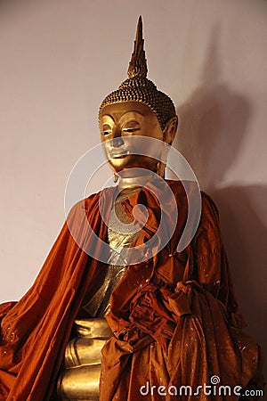 Gold Buddha With Smiling Face And Shadow Stock Photo