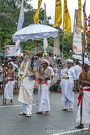 A temple custodian parades during the Day Perahera. Editorial Stock Photo