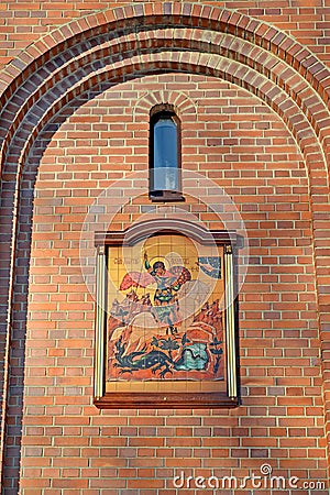 Temple icon in an arched niche on the facade of the chapel of St. George the Victorious. Kaliningrad Editorial Stock Photo