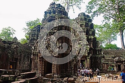 Temples in Ta Prohm, Angkor, Cambodia. Jungle temple with massive trees growing out of its walls Editorial Stock Photo