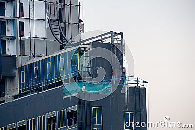Temporary office built from container on the deck of construction of tall apartment building Stock Photo