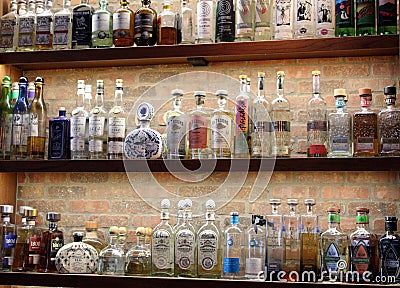 Long wood shelves covered with bottles of booze that make tasty drinks, Cantina Restaurant, Saratoga, NY, 2020 Editorial Stock Photo