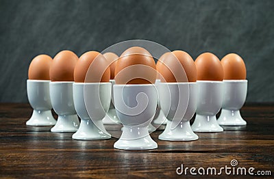 Ten Boiled Eggs in Egg Cups on a Table Stock Photo