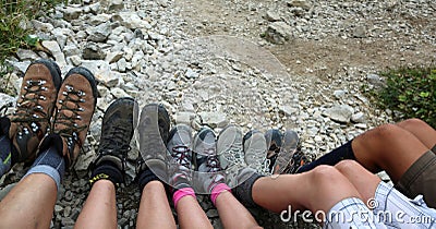 Ten legs of the five-person family while resting after the hike Stock Photo