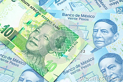 A ten South African rand bank note on a bed of Mexican peso notes Editorial Stock Photo