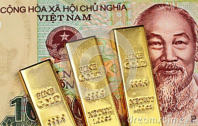 A ten thousand Vietnamese dong note with three gold bars Stock Photo