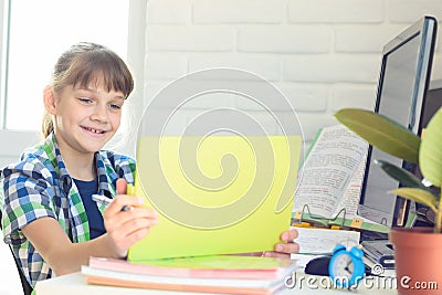 A ten year old girl happily looks at the screen of a tablet computer Stock Photo