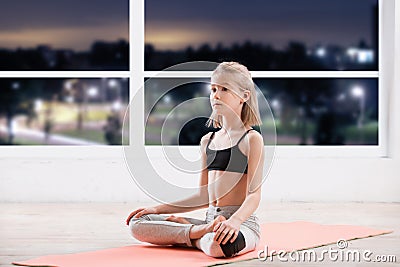 Ten years girl strething at fitness class Stock Photo