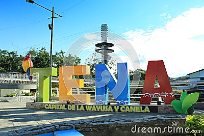 Tena, written in letters and put on the main plaza in tena with in the back the espiral Editorial Stock Photo