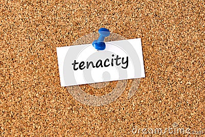 Tenacity. Word written on a piece of paper, cork board background Stock Photo