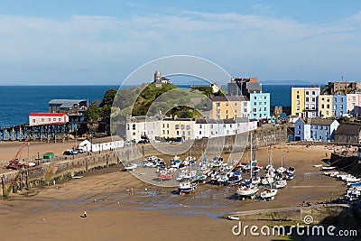 Tenby South Wales uk in summer with tourists and visitors and blue sky and boats in harbour Editorial Stock Photo