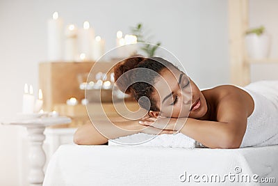 Tender african girl resting relaxing with closed eyes in spa salon. Stock Photo
