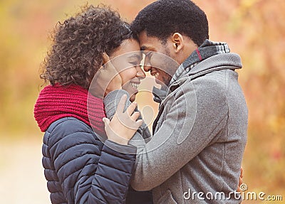 Tender afro couple bonding to each other, touching foreheads Stock Photo