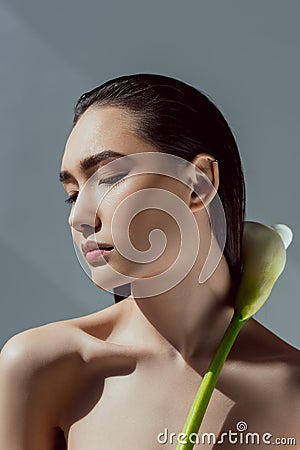 tender asian girl with closed eyes holding calla flower Stock Photo