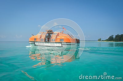 Tender boat on clear ocean water Editorial Stock Photo