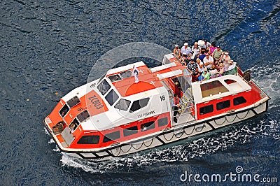 Tender boat transferring passengers to the cruise ship Editorial Stock Photo