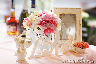 Tender decor of a table with lettering 'love', pink and white fl Stock Photo