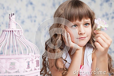 Tender dreamy romantic girl looking at flower Stock Photo