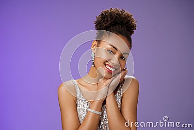 Tender elegant wealthy young african american rich woman in brilliants silver stylish shiny dress lean head shoulder Stock Photo