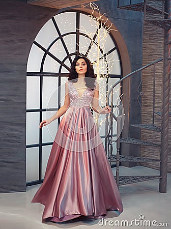 Tender gorgeous graceful lady at vintage stairs, girl in long gorgeous pink tender dress with sparkles, attractive Stock Photo