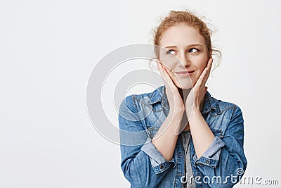 Tender happy redhead european student holding hands on cheeks as if being embarrassed or touched, looking aside and Stock Photo