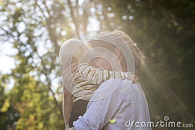Tender loving moment between a young father and his toddler son Stock Photo