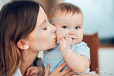 Tender loving young mother kissing her baby Stock Photo