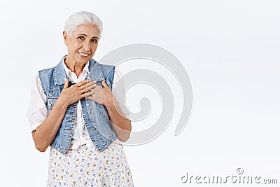 Tender, pleased, touched charming lovely senior woman with combed grey hair, flattered with nice gift, family reunion Stock Photo