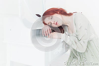 Tender retro portrait of a young beautiful dreamy redhead woman. Stock Photo