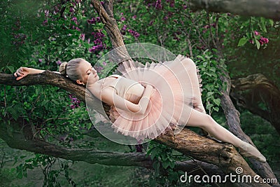 Tender and romantic ballerina relaxing in flowers garden Stock Photo