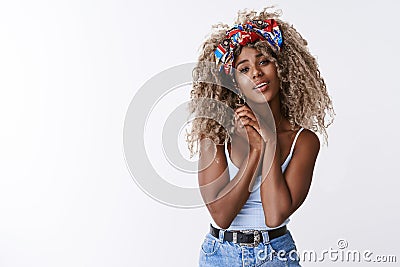Tender and stylish, modern attractive blond african-american girl with afro hairstyle, sighing romantically, look at Stock Photo